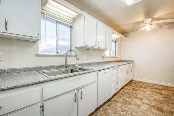 a kitchen with sink and window