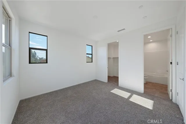 an empty room with windows and closet