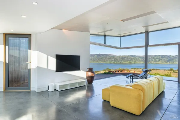 a living room with fireplace furniture and a large window