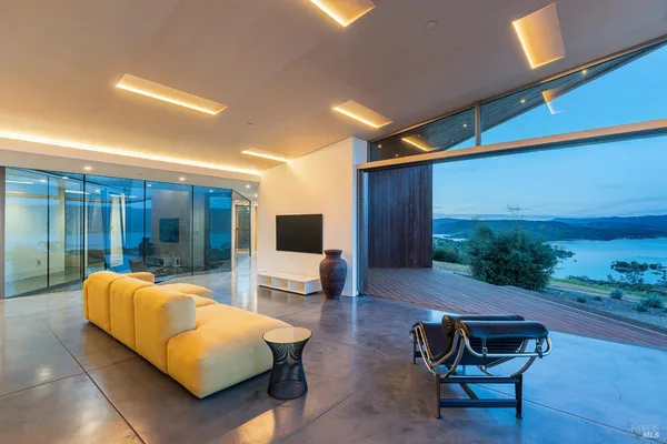 a living room with furniture and a floor to ceiling window