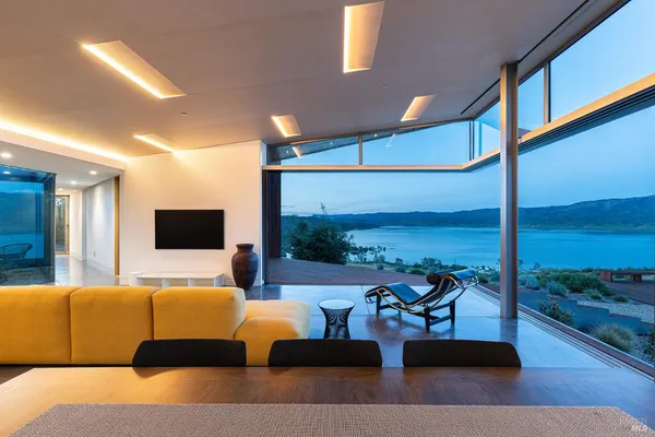 a view of a house with backyard and sitting area