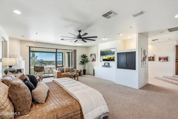 a spacious bedroom with a bed and window