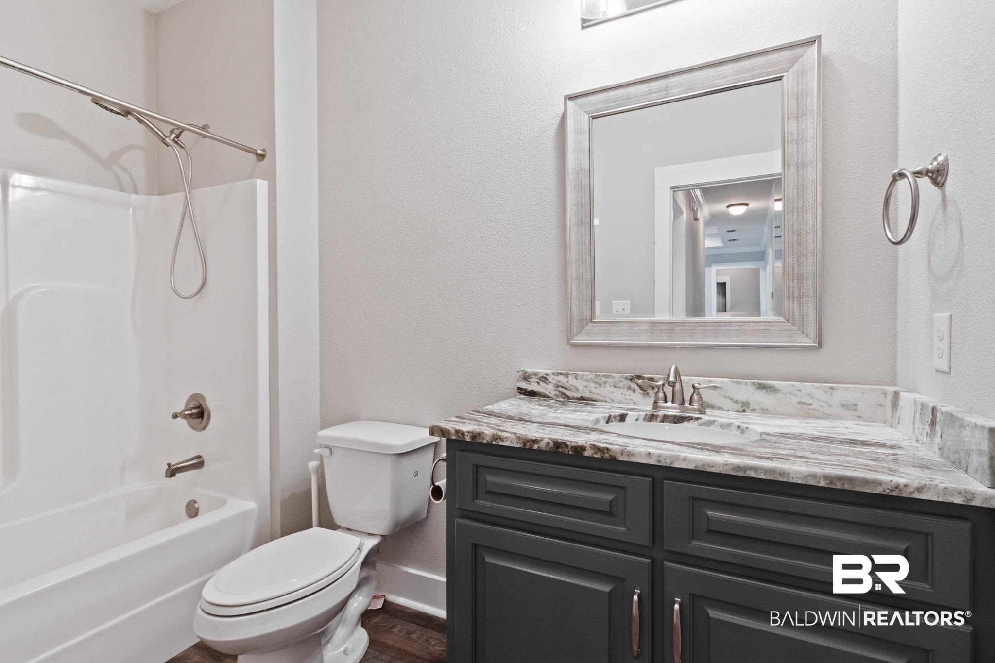 17376 Bankhead Boulevard Fairhope, AL 36532 - Photo 51 of 73 Bathroom with shower combination, vanity, and a textured wall