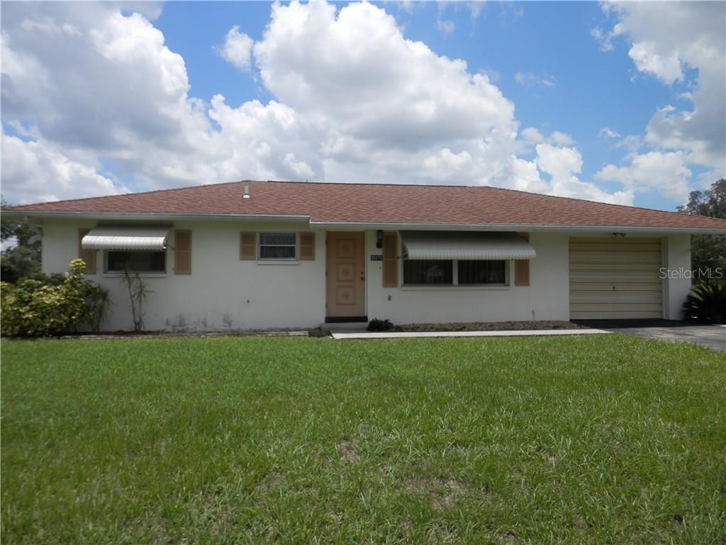 30073 Holly Road Punta Gorda, FL 33982 - Photo 1 of 1 a front view of a house with a garden