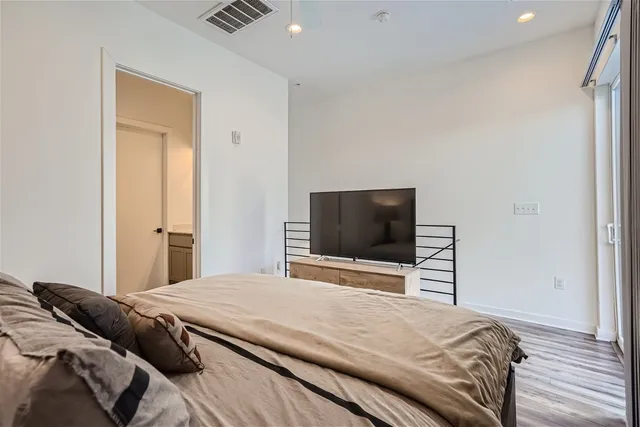 a bedroom with a bed and a flat screen tv