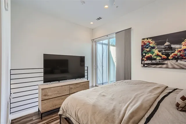 a bedroom with a bed and a flat screen tv