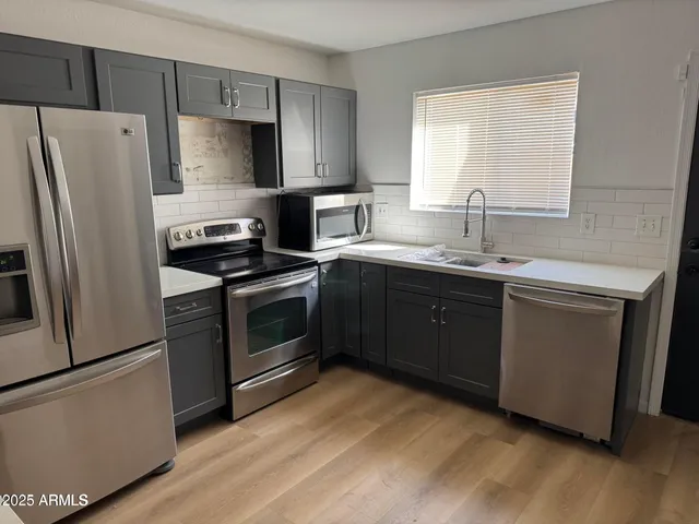 a kitchen with a sink stove and refrigerator
