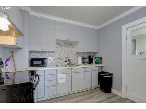 a kitchen with stainless steel appliances a stove a sink and a refrigerator