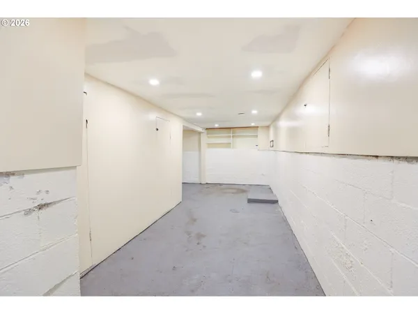 a view of a house with a big yard potted plants and large tree