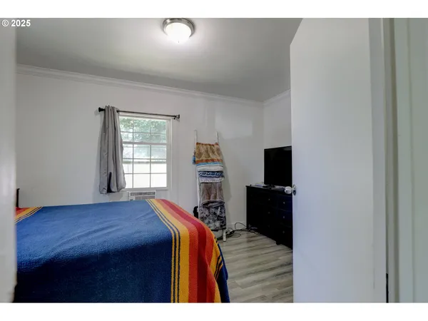 a bedroom with a bed and a television