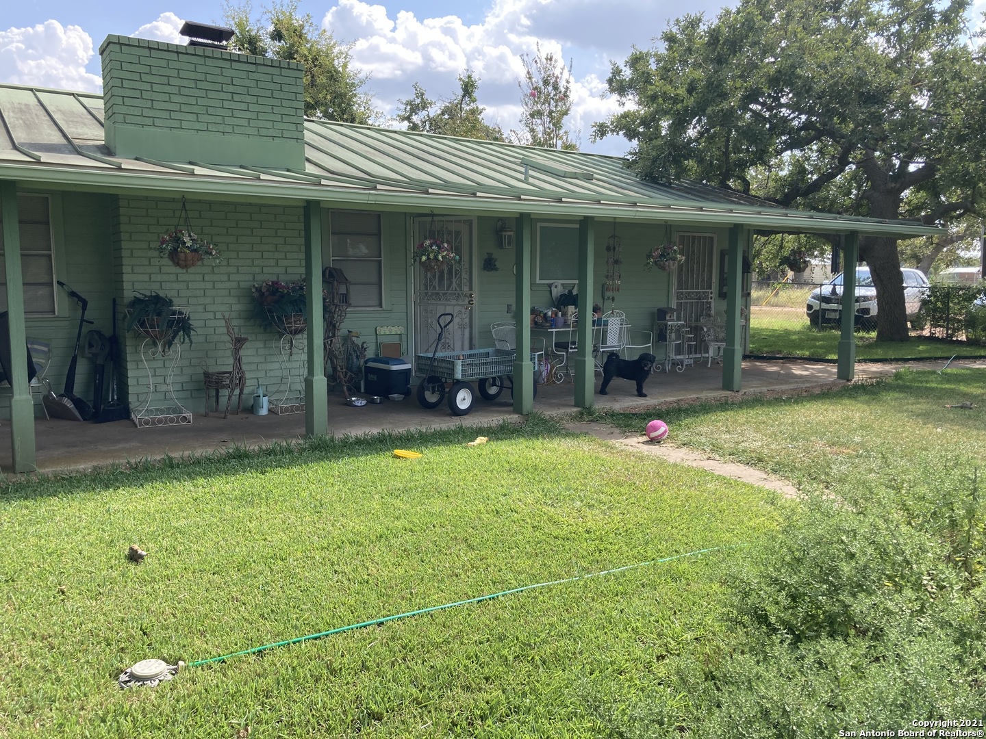 a view of a house with backyard porch and sitting area