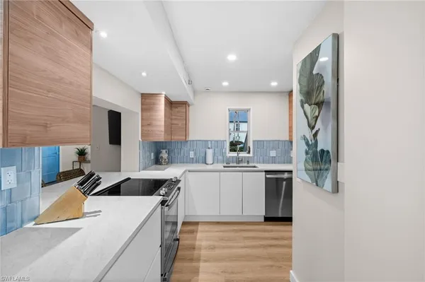 a kitchen with a sink cabinets and window