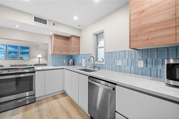 a kitchen with a sink and a stove top oven