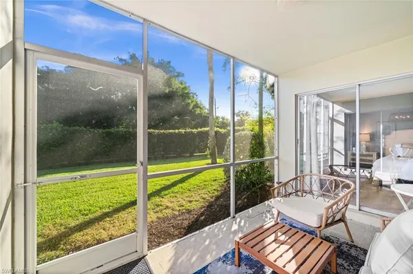 a living room with a large window and table