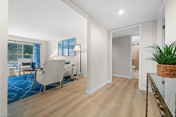 a view of hallway with wooden floor and furniture
