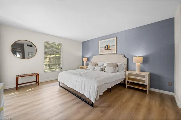 a bedroom with a large bed and a large window