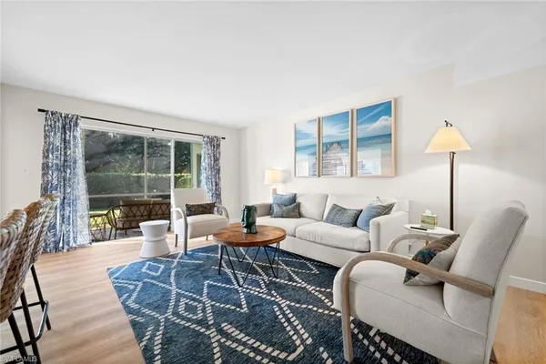 a living room with furniture and a lamp