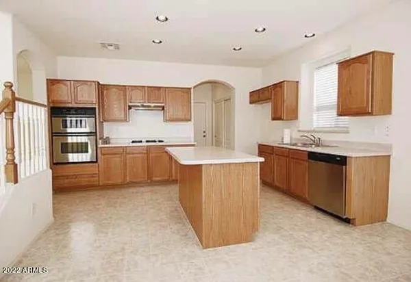 a large kitchen with stainless steel appliances granite countertop a stove a sink dishwasher and a refrigerator