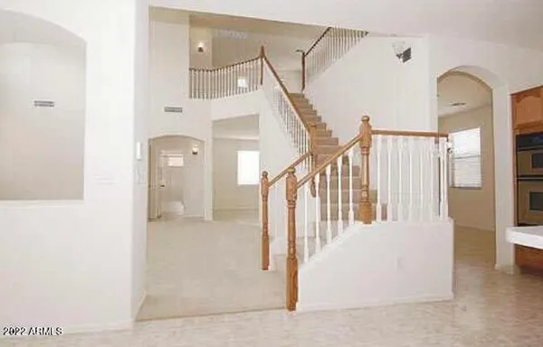 a view of staircase with white walls and railing