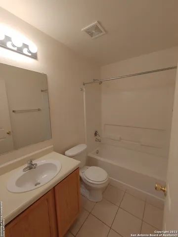 a bathroom with a sink toilet vanity and shower