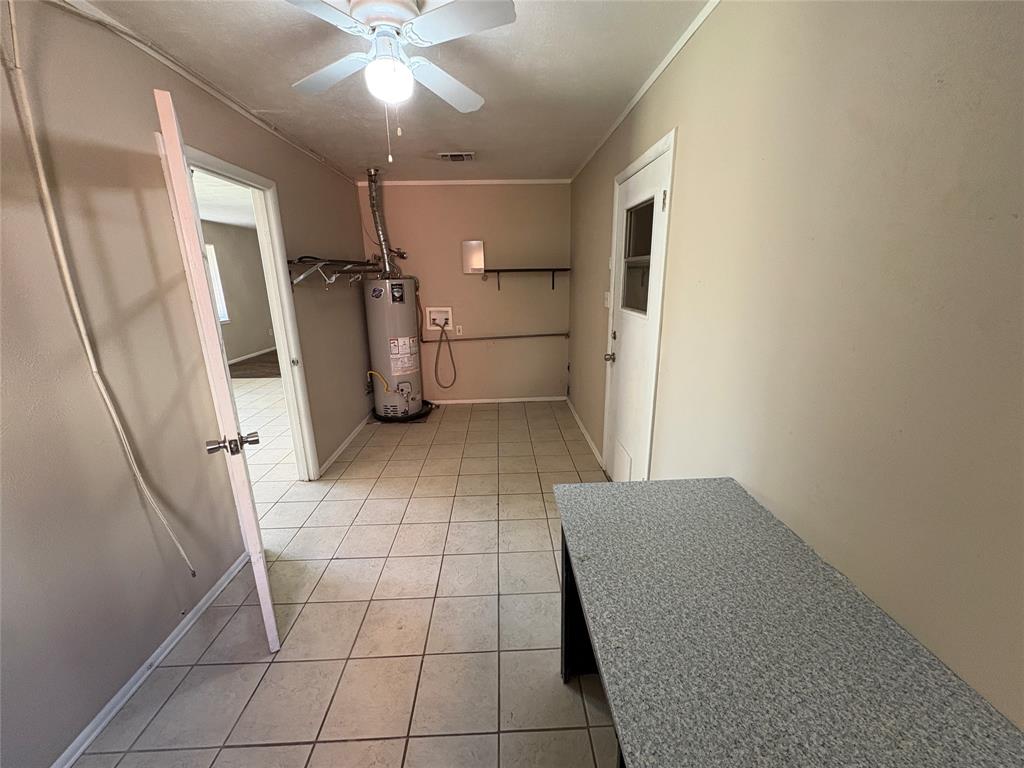 1111 Duane Street Benbrook, TX 76126 - Photo 13 of 28 a view of a livingroom with an empty space and a stove top oven