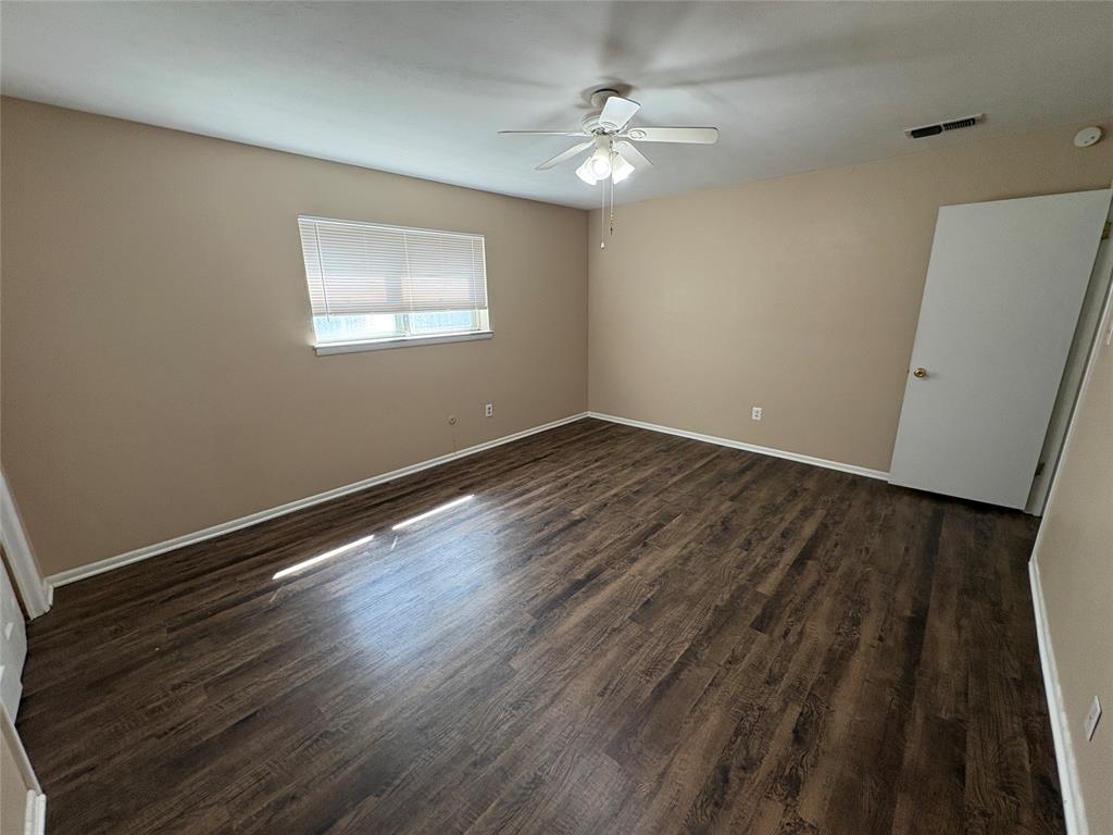 1111 Duane Street Benbrook, TX 76126 - Photo 19 of 28 wooden floor in an empty room with a window