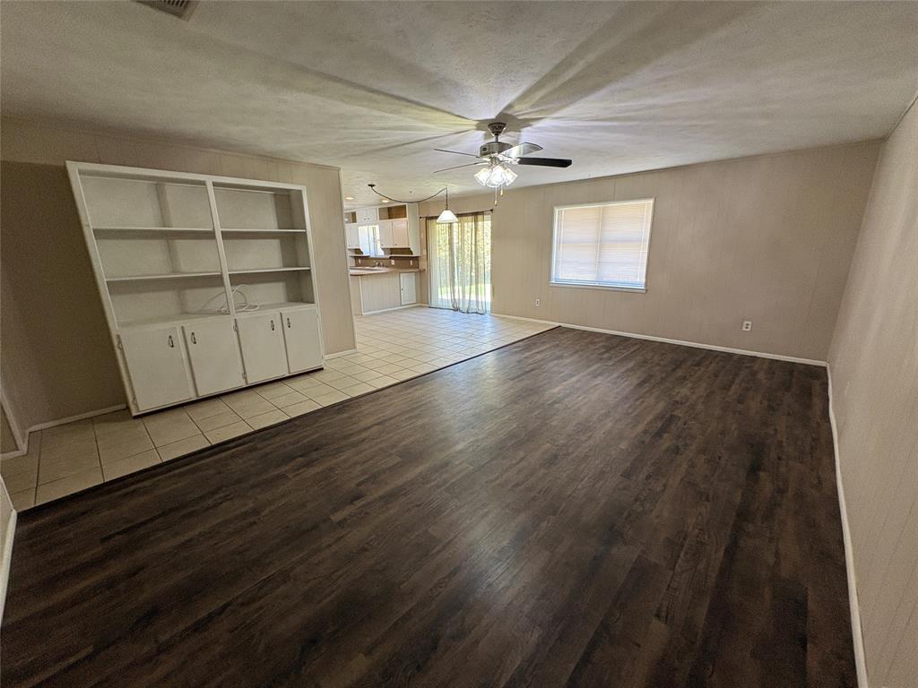 1111 Duane Street Benbrook, TX 76126 - Photo 3 of 28 wooden floor in an empty room with a window