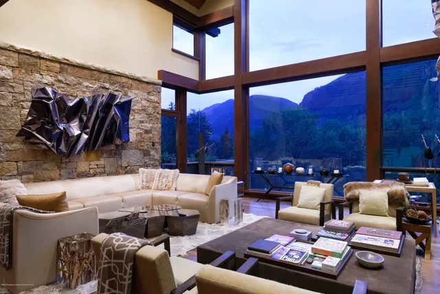 a kitchen with a sink a counter top space and living room filled with furniture