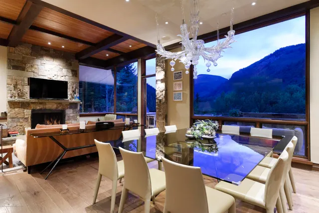 a view of a dining room with furniture and chandelier