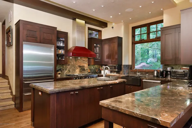 a view of hall way with furniture and chandelier