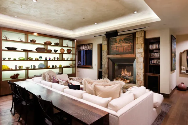 a bedroom with a bed a chandelier and flat screen tv