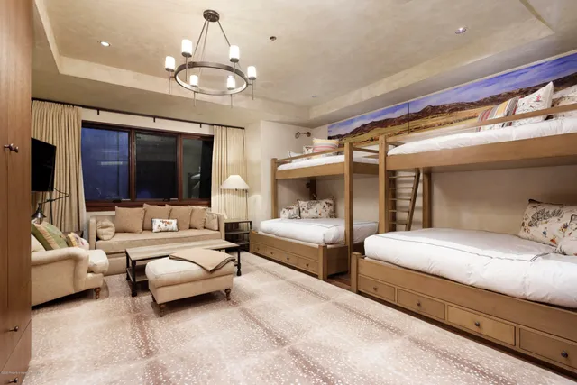 a view of a swimming pool with lounge chairs in patio