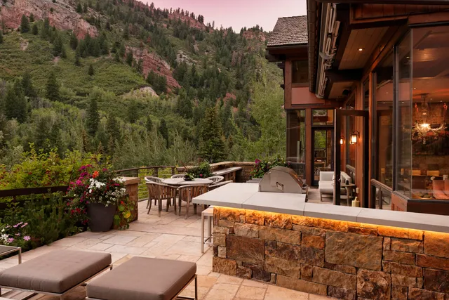 a view of a chairs and table in the back yard of the house