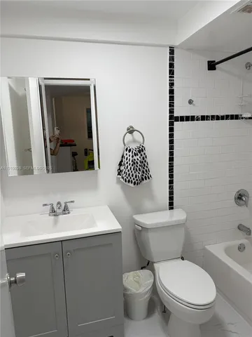 a bathroom with a toilet sink shower and mirror