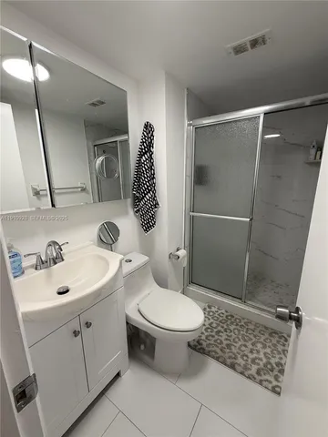 a bathroom with a sink toilet and shower