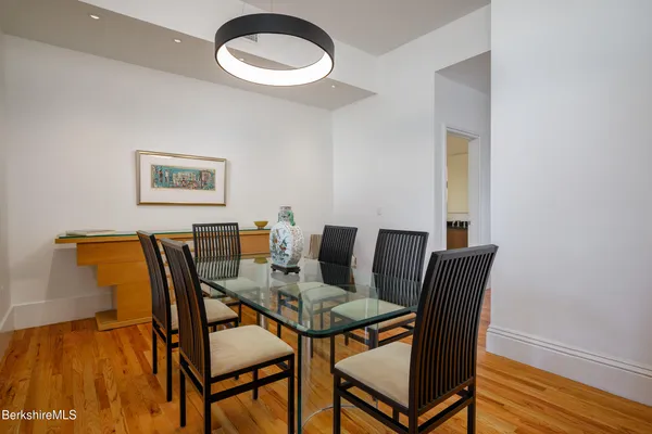 a view of a dining room with furniture and wooden floor