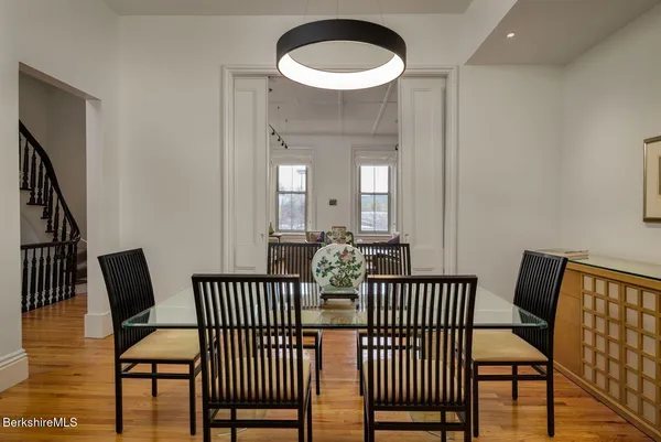 a view of a room with furniture and wooden floor