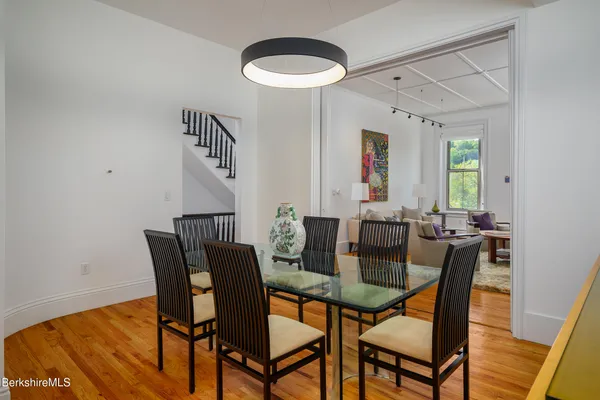 a view of a dining room with furniture and wooden floor