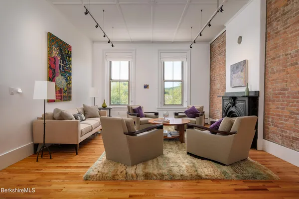 a living room with furniture and a fireplace