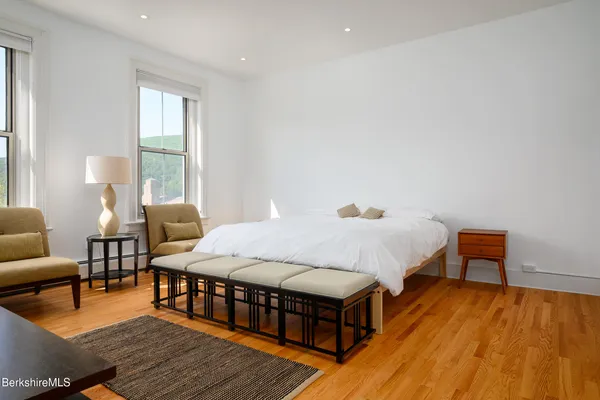 a bed room with a bed and a chair