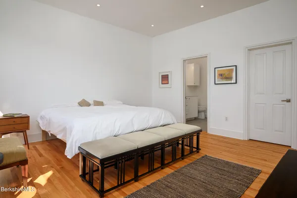 a bed room with a bed and a night stand