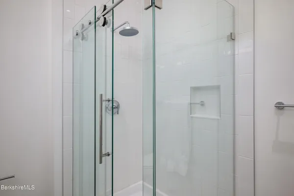 a bathroom with a shower and a glass door