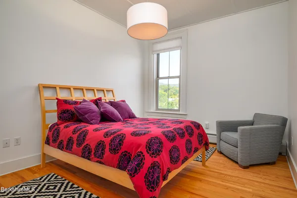 a bedroom with a bed and a chair