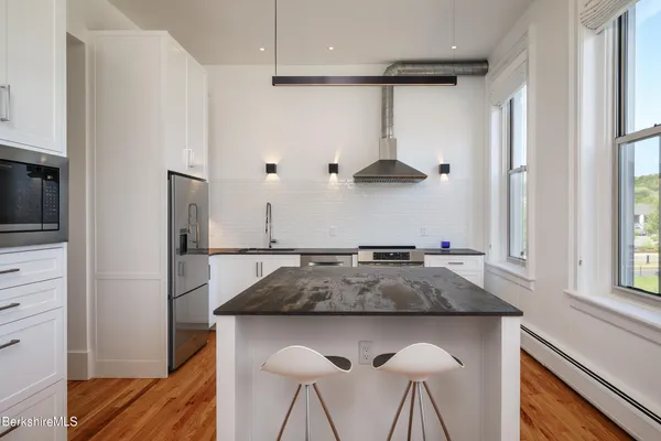 a kitchen with a table and chairs in it