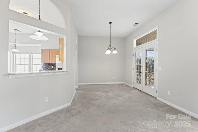 a view of an empty room with window and cabinet