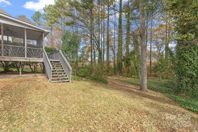a view of a house with a backyard