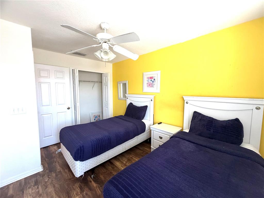4573 Ada Lane Kissimmee, FL 34746 - Photo 14 of 37 a bedroom with a bed and wooden floor