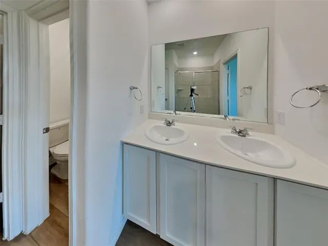 a bathroom with a double vanity sink and a mirror