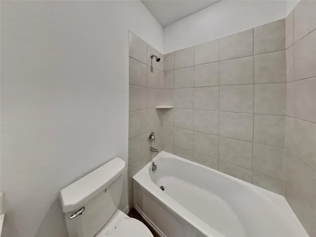a bathroom with a bathtub and toilet