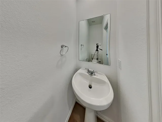 a bathroom with a sink a mirror and toilet